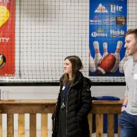 Three alumni socializing at the Fowling Fun Event